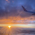 A view from the airplane window towards the sun